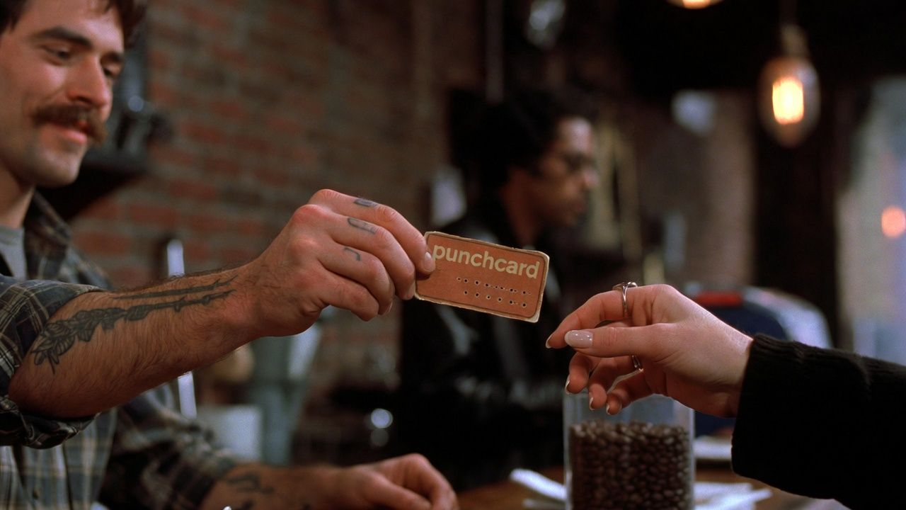 Customer receiving a punchcard at a coffee bar
